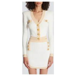 Cardigan court en maille à bordures dorées